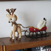 Reindeer with a sleigh a bag for gifts and Christmas tree