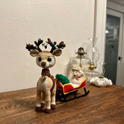 Reindeer with a sleigh a bag for gifts and Christmas tree